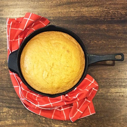Cast Iron Skillet Pumpkin Bread with a red linen.