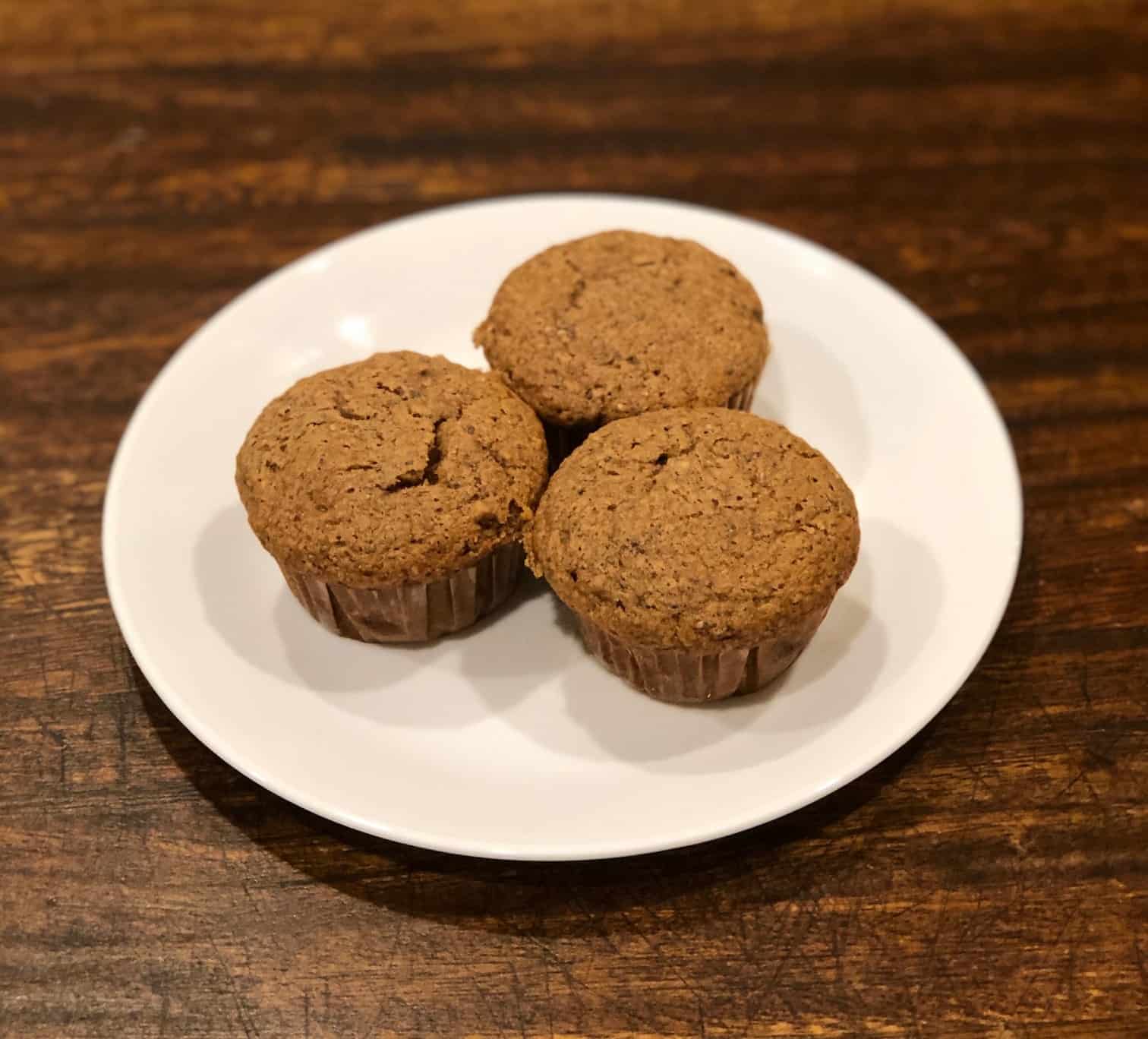 Whole wheat banana muffins on a white plate.