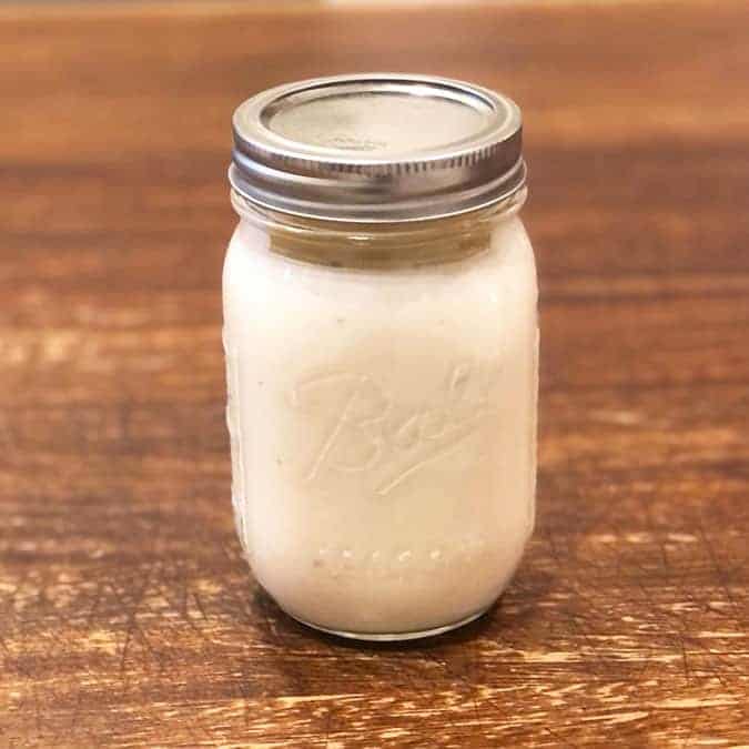 Copycat Outback Ranch Dressing in  mason jar on a wooden background. 