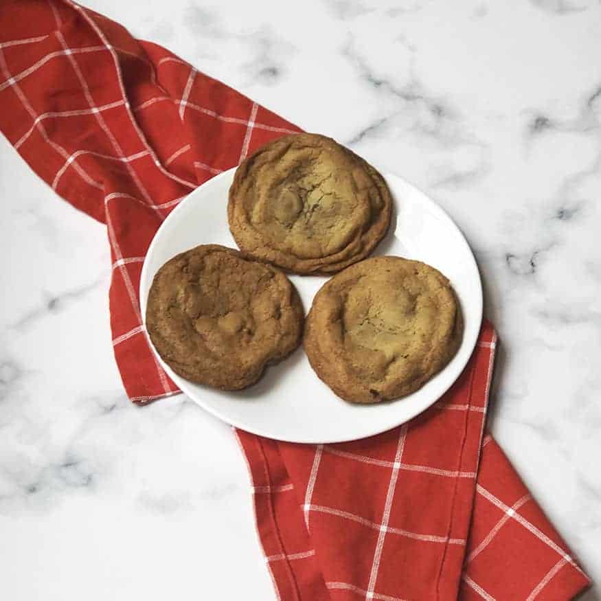 Copycat Great American Cookies Chocolate Chip Cookies on a white plate with a red linen. 