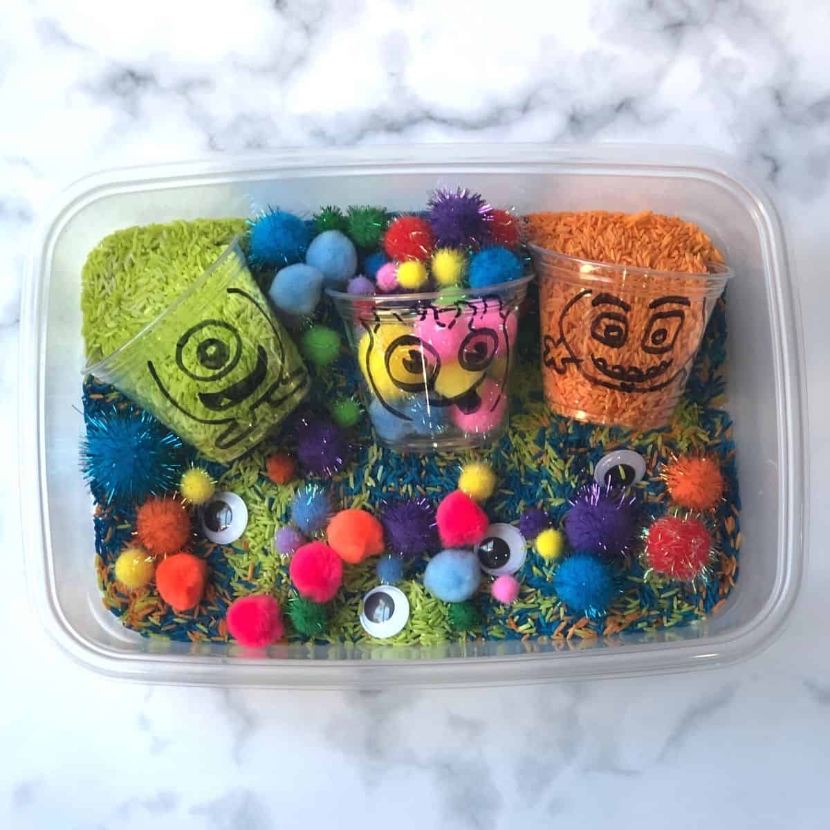  monster sensory bin (dyed rice, pompoms, and googly eyes) 