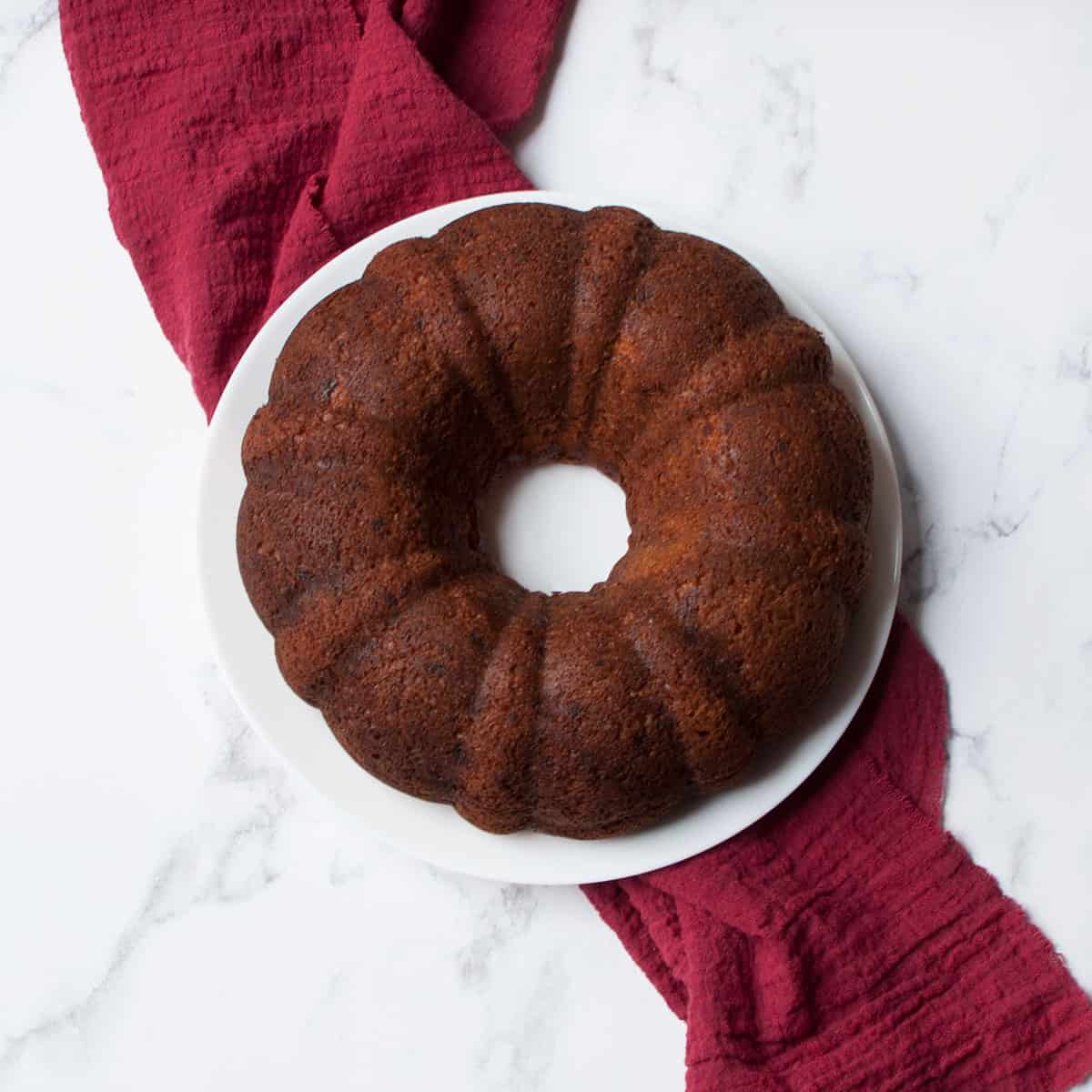 Spice Cake Banana Bread on a plate with a red linen